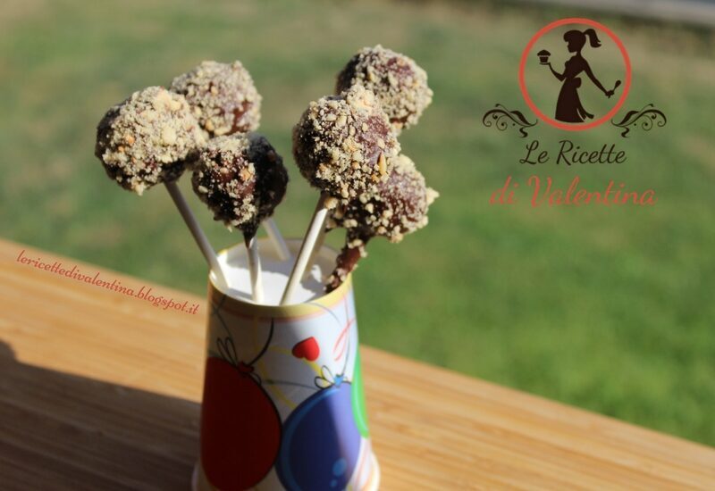 Cake pops di briciole di torta e marmellata ricoperti di cioccolato fondente e nocciole