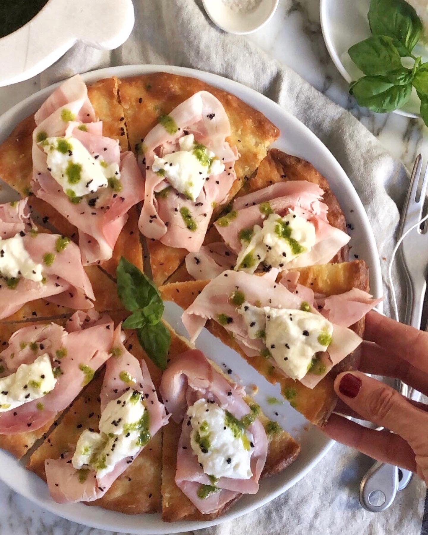 Focaccia ligure, rose di prosciutto cotto, burrata, emulsione di pesto e polvere di olive taggiasche