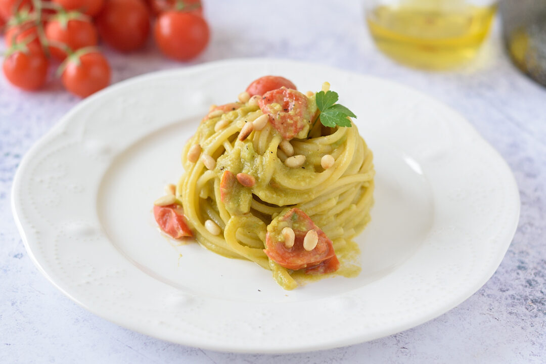 Pasta con crema di avocado, pomodorini e pinoli tostati