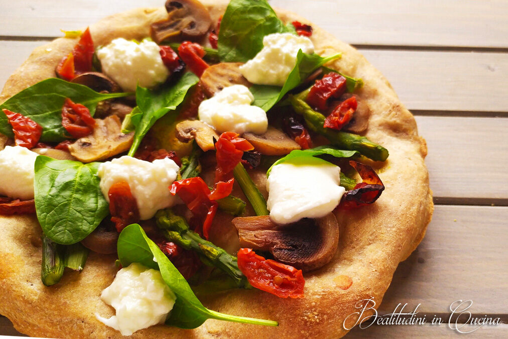 Pizza con pomodori secchi, spinaci, asparagi e spuma di burrata