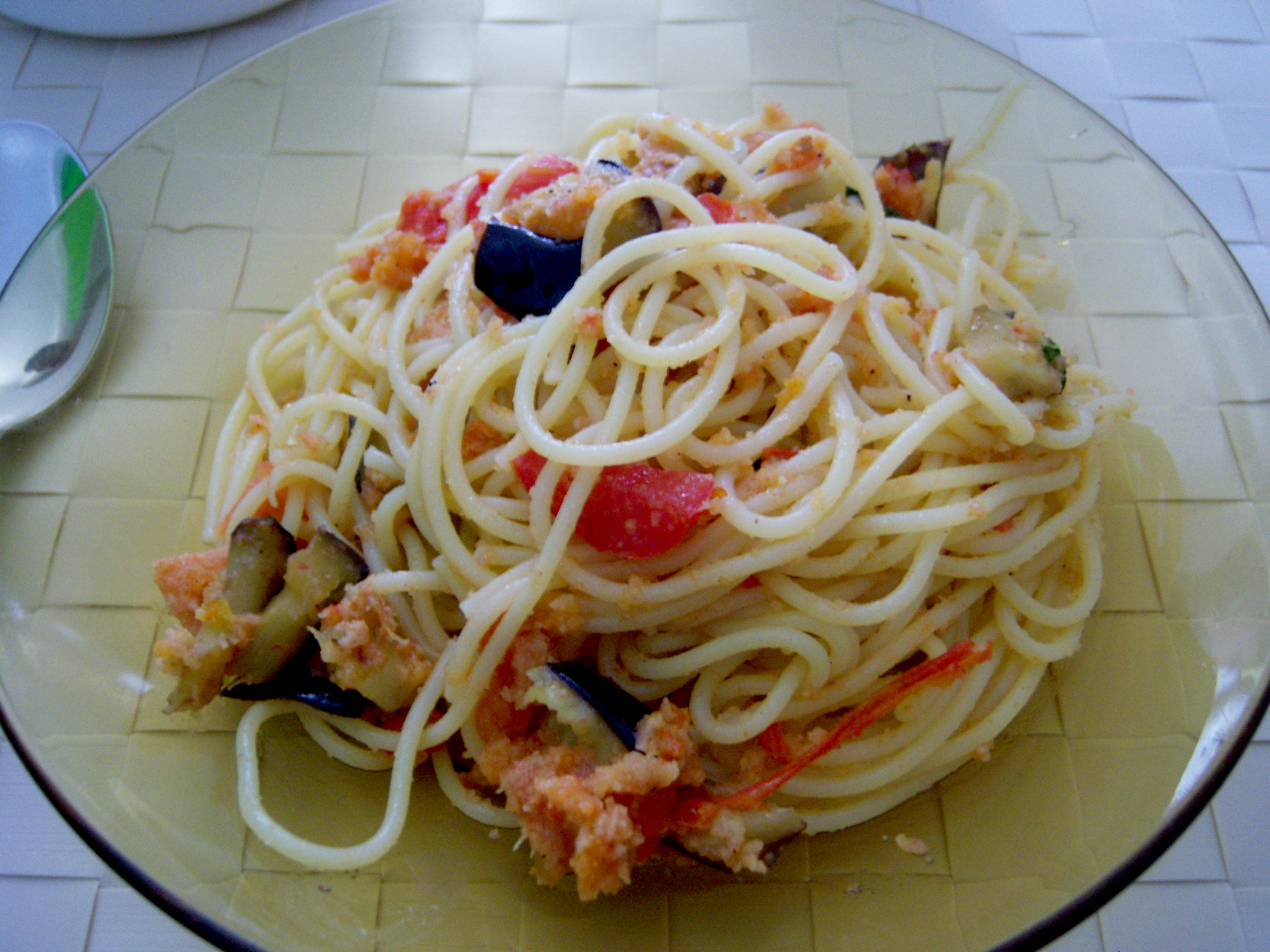 Spaghetto con melanzane, pomodori freschi e pangrattato insaporito.
