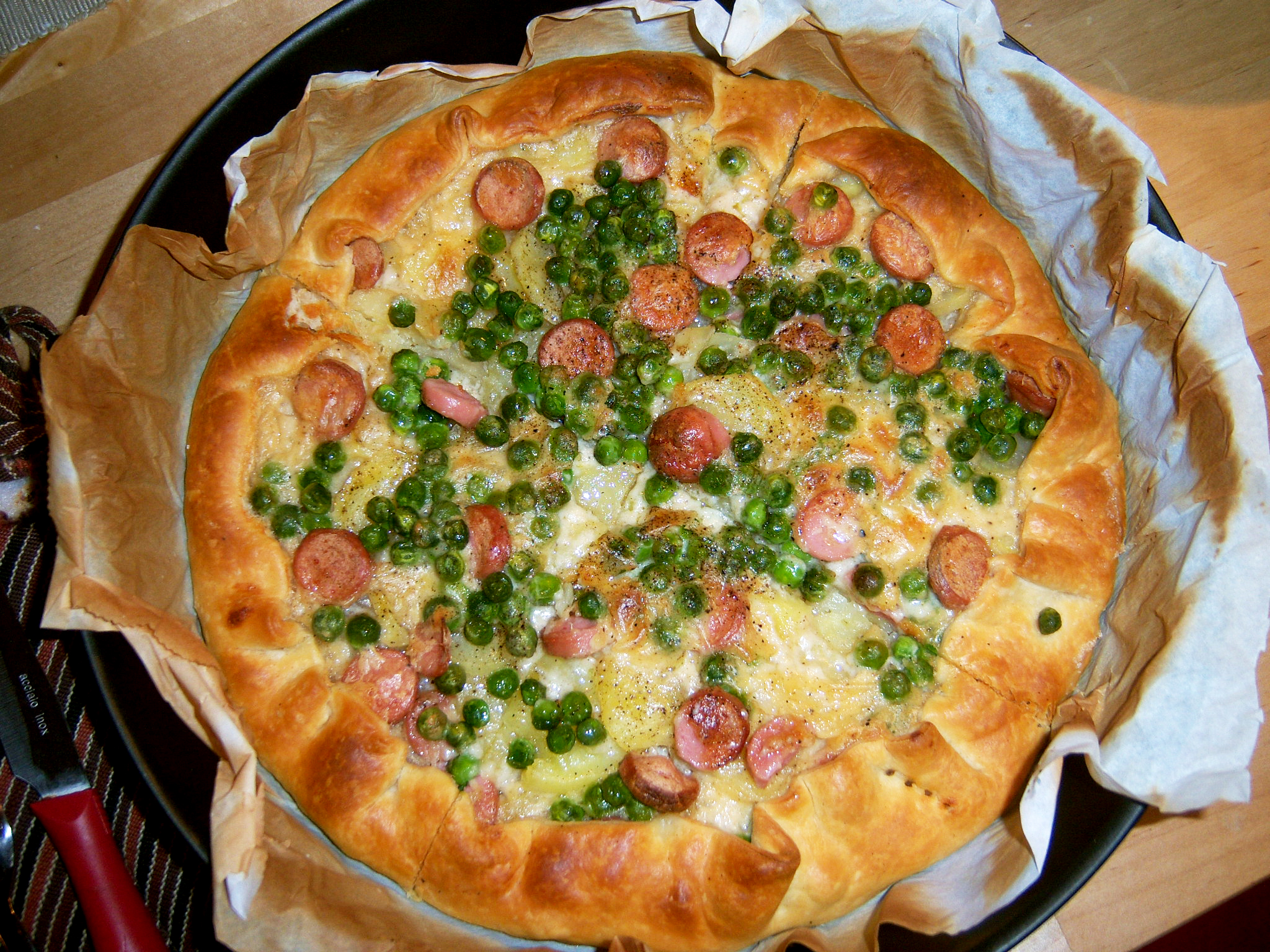 Torta salata di patate, wurstel e pisellini