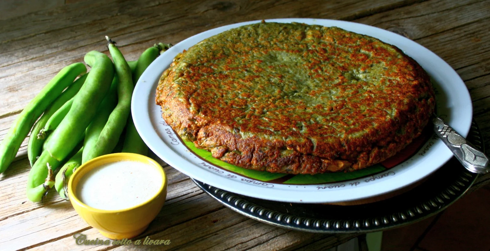 Tortino con bucce di fave e crema di robiola